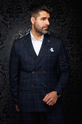 Men's navy plaid blazer on model, front view, with double-breasted buttons and flap pockets by Au Noir