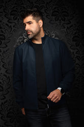 Au Noir men's navy bomber jacket on model, open front zipper, ribbed cuffs and subtle tonal chest logo