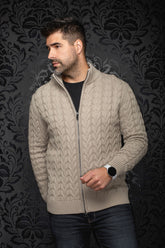 Men's beige cable-knit zip merino sweater shown front on model, with stand collar and ribbed hem by Au Noir