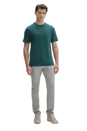 Men's full front model view of a teal short sleeve crewneck T-Shirt worn with light gray pants by Robert Barakett