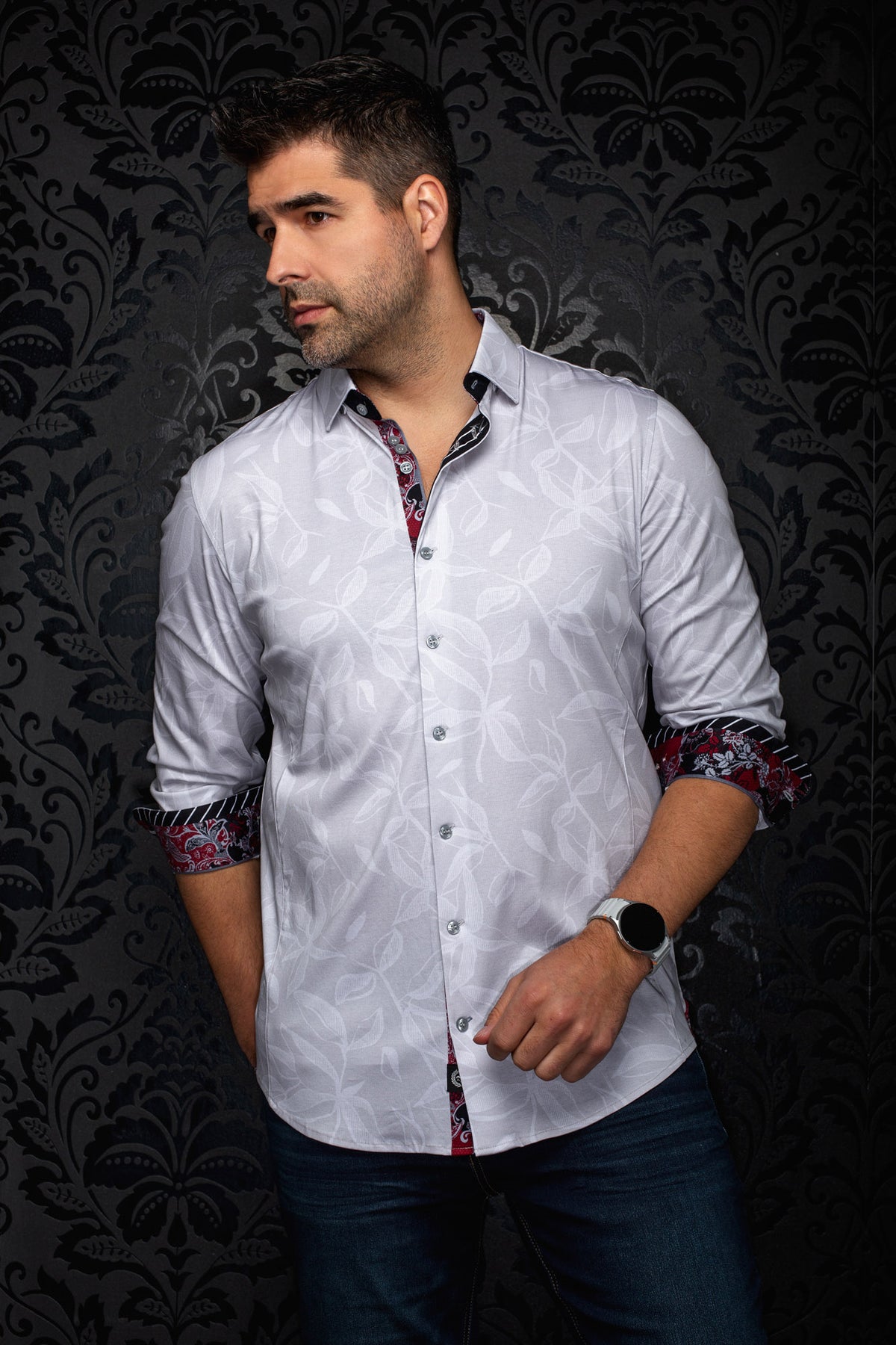 Men's white long sleeve button-up shirt with tonal leaf pattern and rolled red paisley cuffs, side view by Au Noir