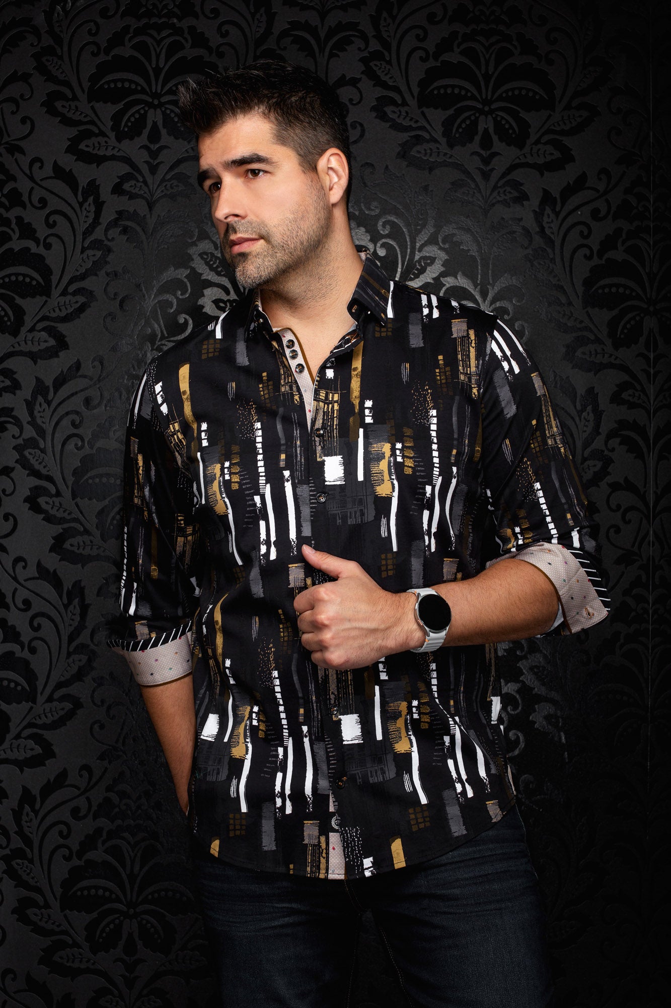 Au Noir men's black button-up shirt with white, gray, and gold abstract print and contrast cuffs shown from the front