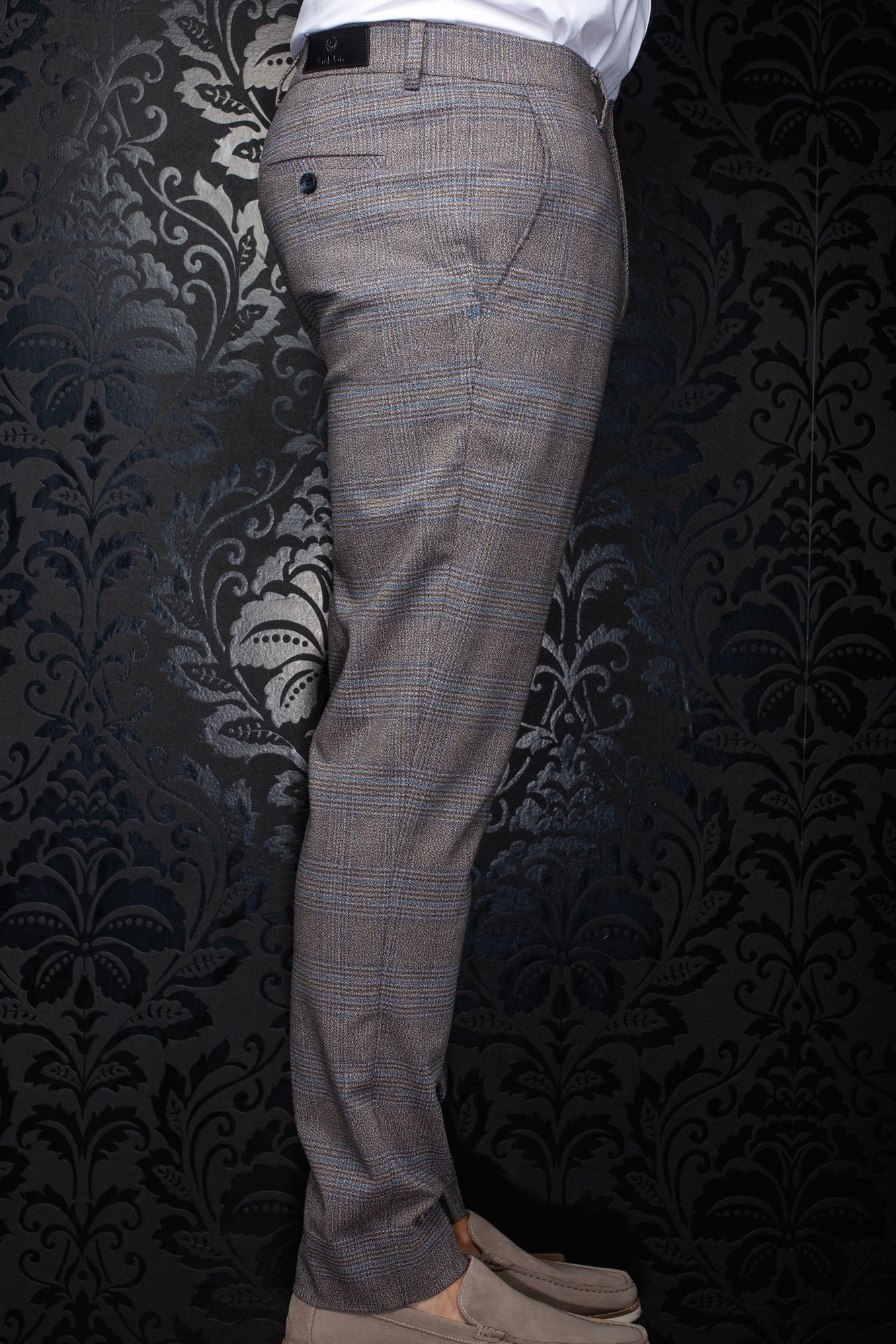 Pantalon à carreaux brun en vue de côté, avec poche arrière boutonnée et étiquette noire pour homme par Au Noir