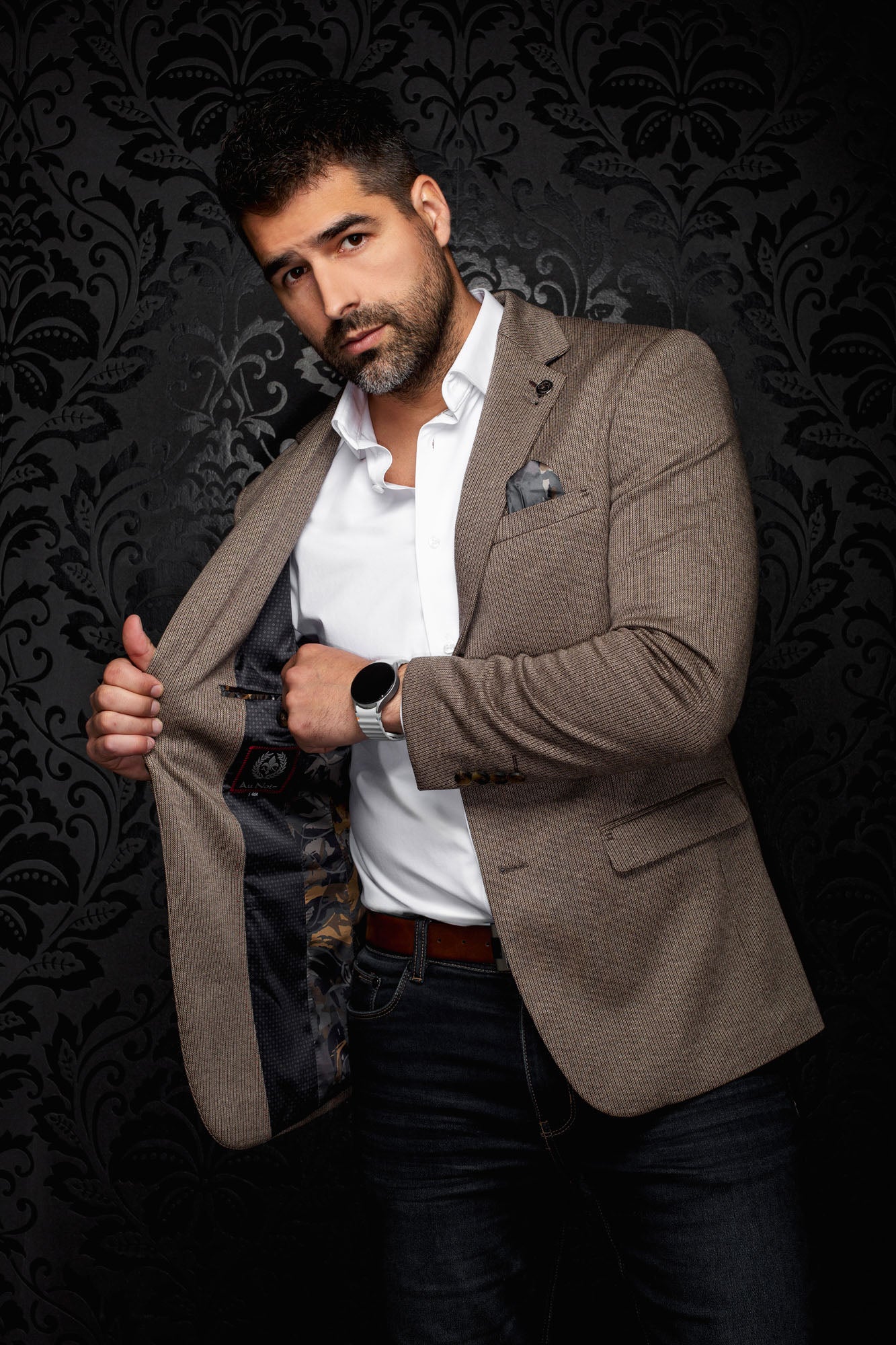 Men's open brown textured blazer showing dark patterned lining, notched lapel, and flap pocket, detail view by Au Noir