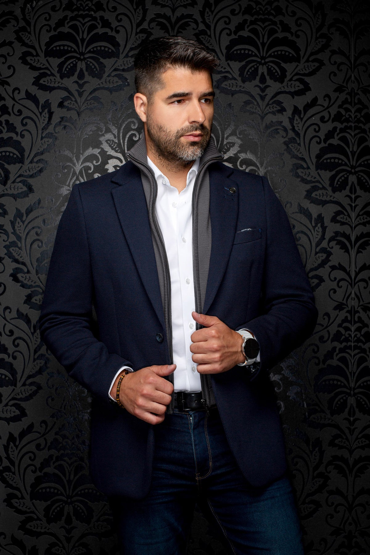 Au Noir men's navy textured blazer with notch lapels and a gray zip-front inner layer, front view