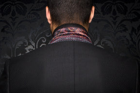 Men's back close-up of a black textured blazer with patterned collar lining and center back seam by Au Noir