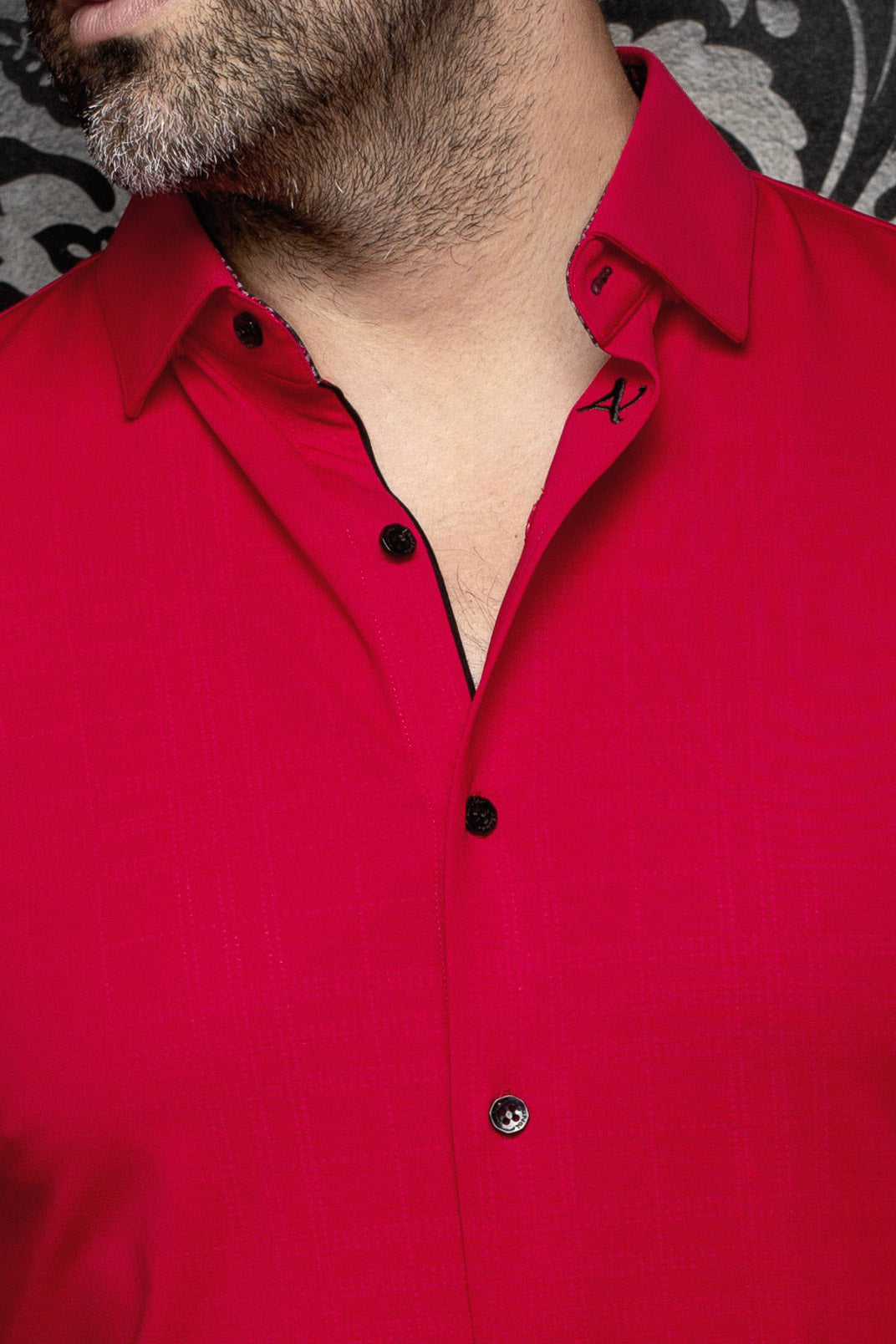 Au Noir men's red button-up shirt collar with black buttons, black trim, and small A embroidery, close-up