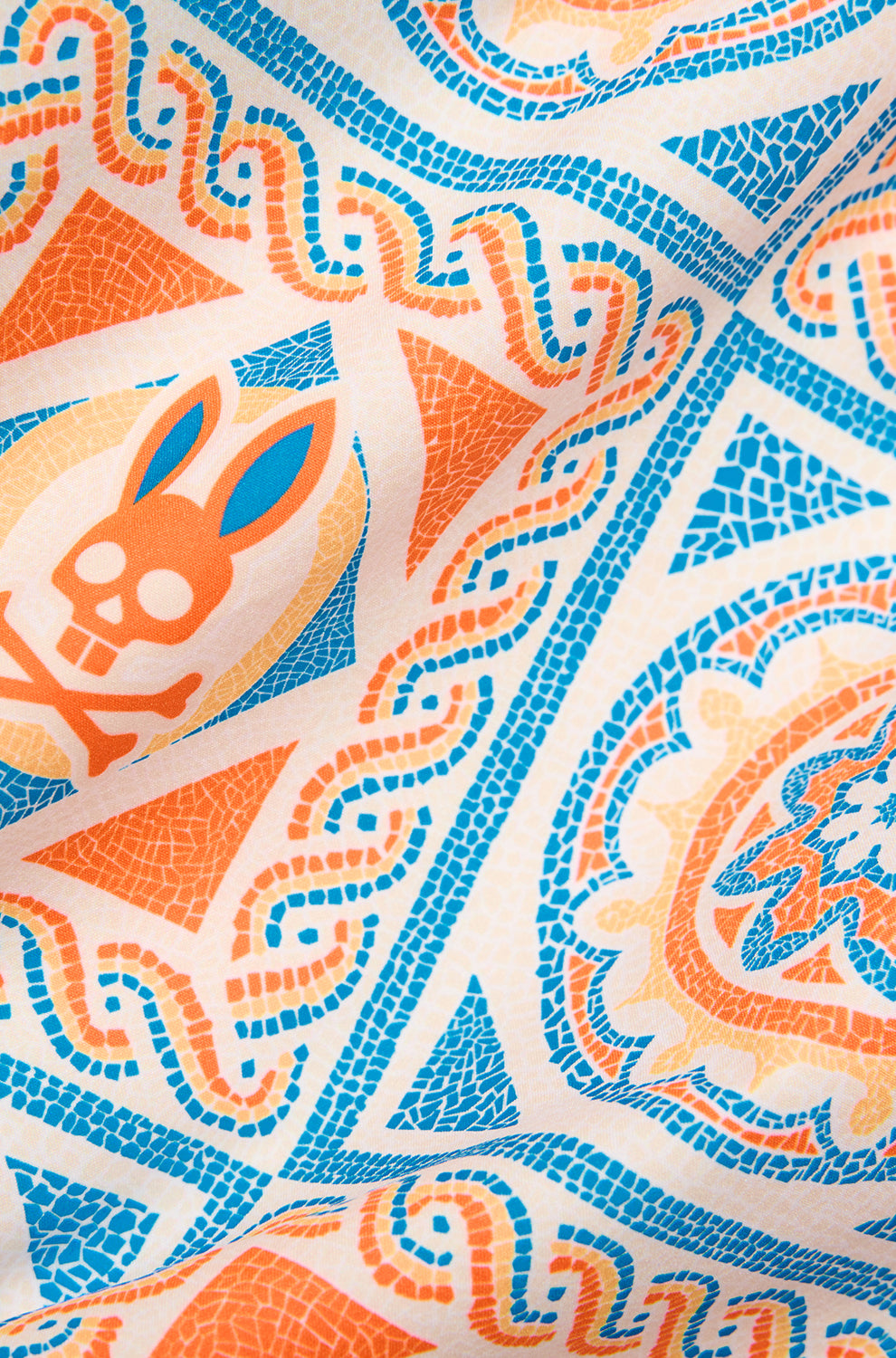 Tissu crème à imprimé mosaïque orange et bleu avec motif tête de lapin pour homme par Psycho Bunny, en gros plan