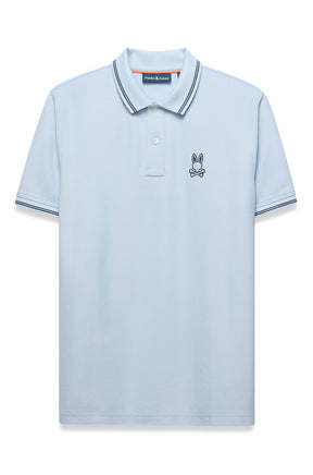 Psycho Bunny men's light blue polo with striped collar and cuffs, button placket, and chest logo shown from the front