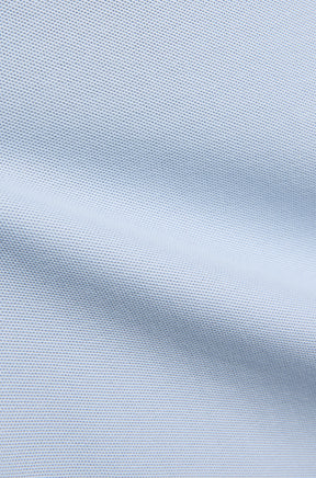 Psycho Bunny men's light blue piqué knit fabric with a seam-like fold and fine textured weave, close-up