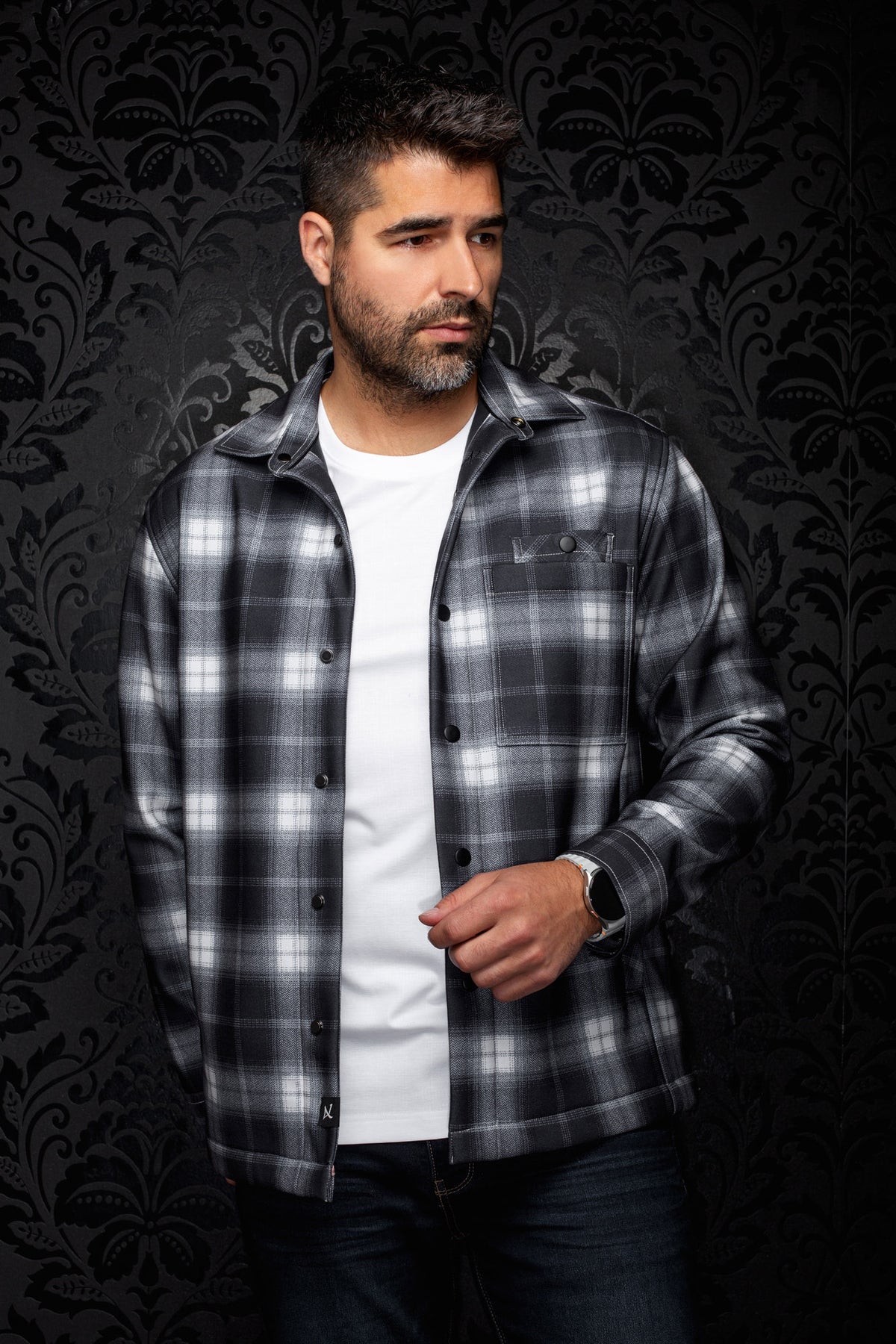 Au Noir men's black and gray plaid overshirt with snap front, chest pocket, and spread collar shown from the front