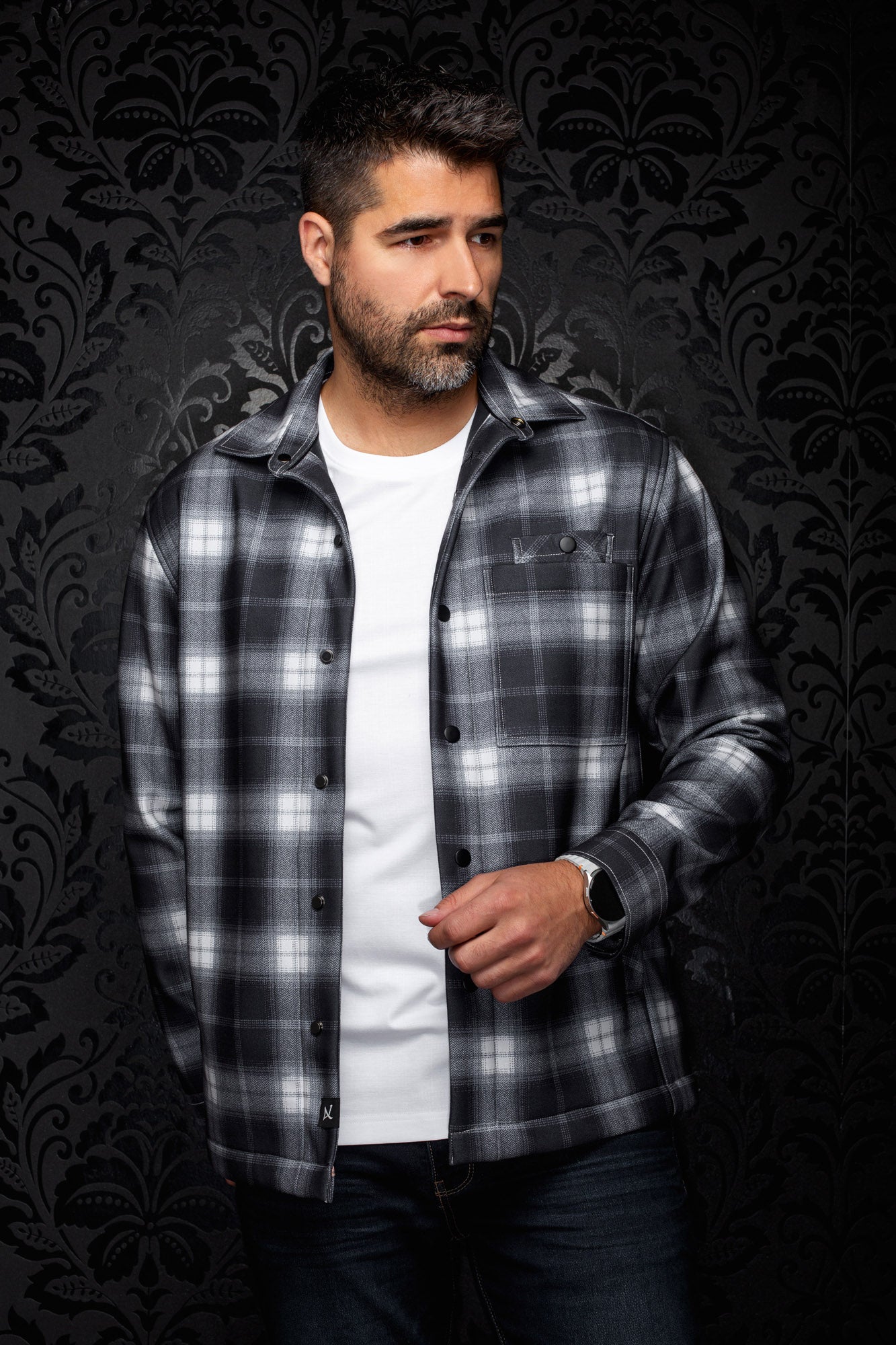 Au Noir men's black and gray plaid overshirt with snap front, chest pocket, and spread collar shown from the front