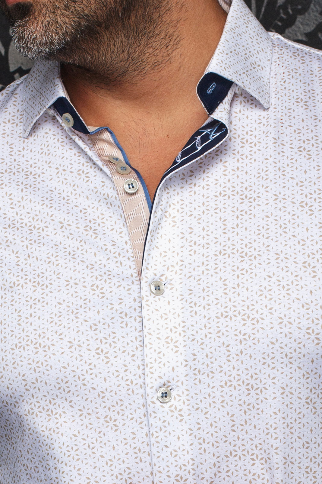 Au Noir men's white patterned button-up shirt collar with navy and beige contrast placket details, close-up