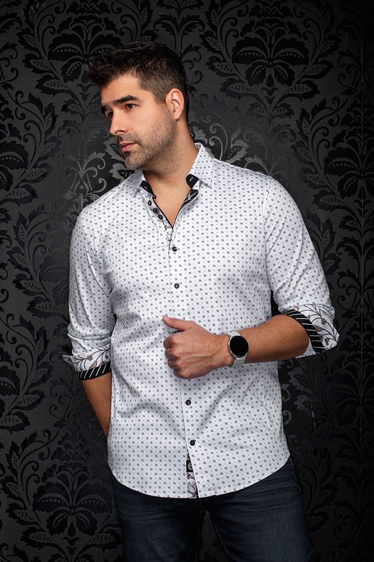 Au Noir men's angled front view of white geometric print shirt with rolled cuffs showing contrast trim
