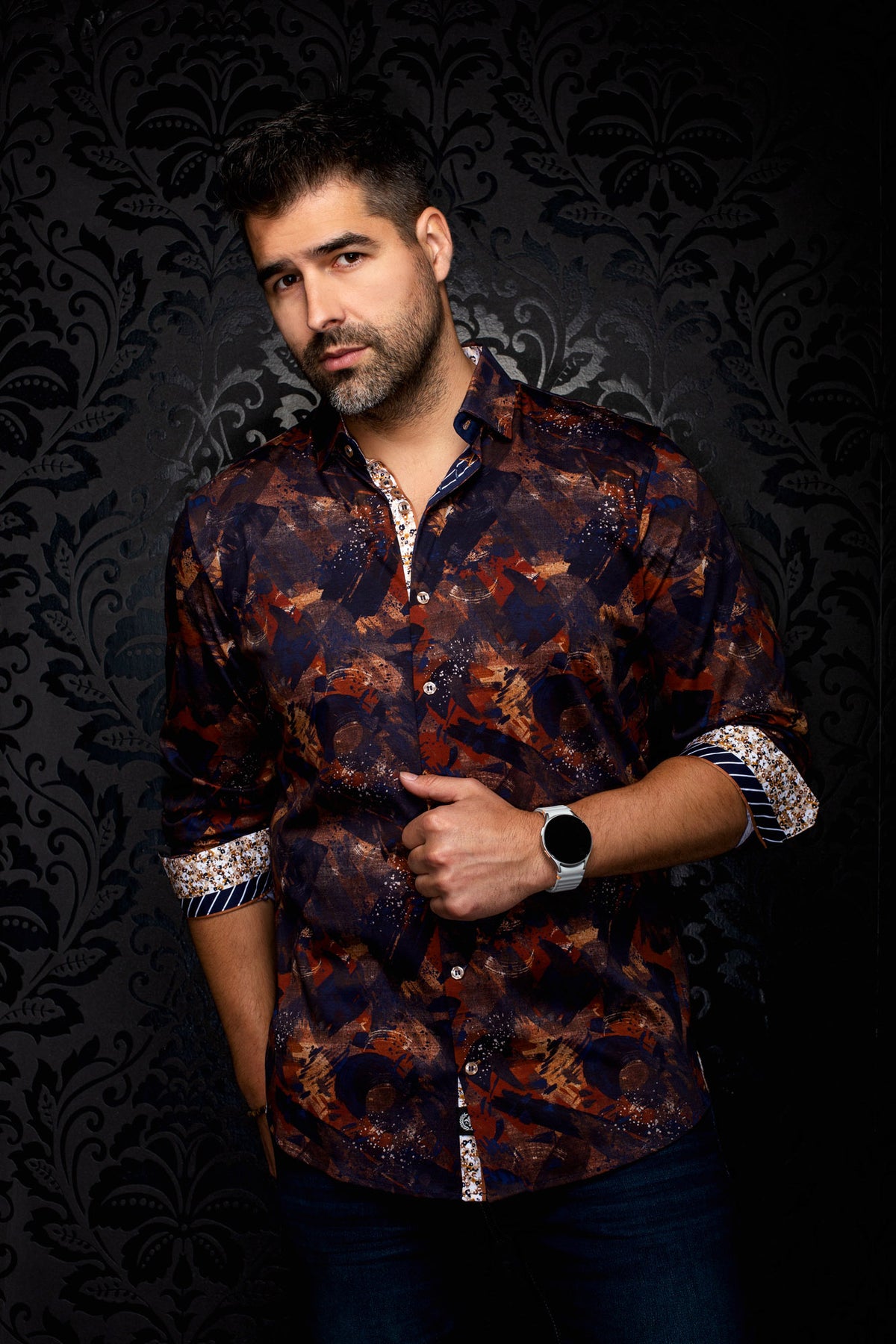 Men's angled front view of navy abstract print shirt with rolled sleeves and patterned cuffs by Au Noir