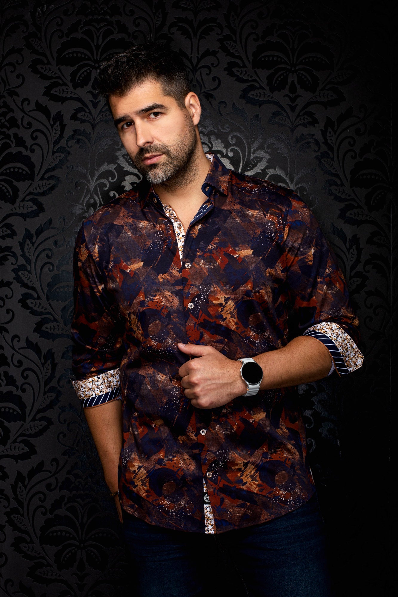Men's angled front view of navy abstract print shirt with rolled sleeves and patterned cuffs by Au Noir