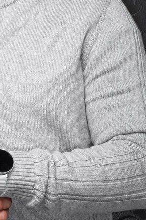 Au Noir men's detail of light gray knit cashmere jacket sleeve with raised ribbed panels and ribbed cuff