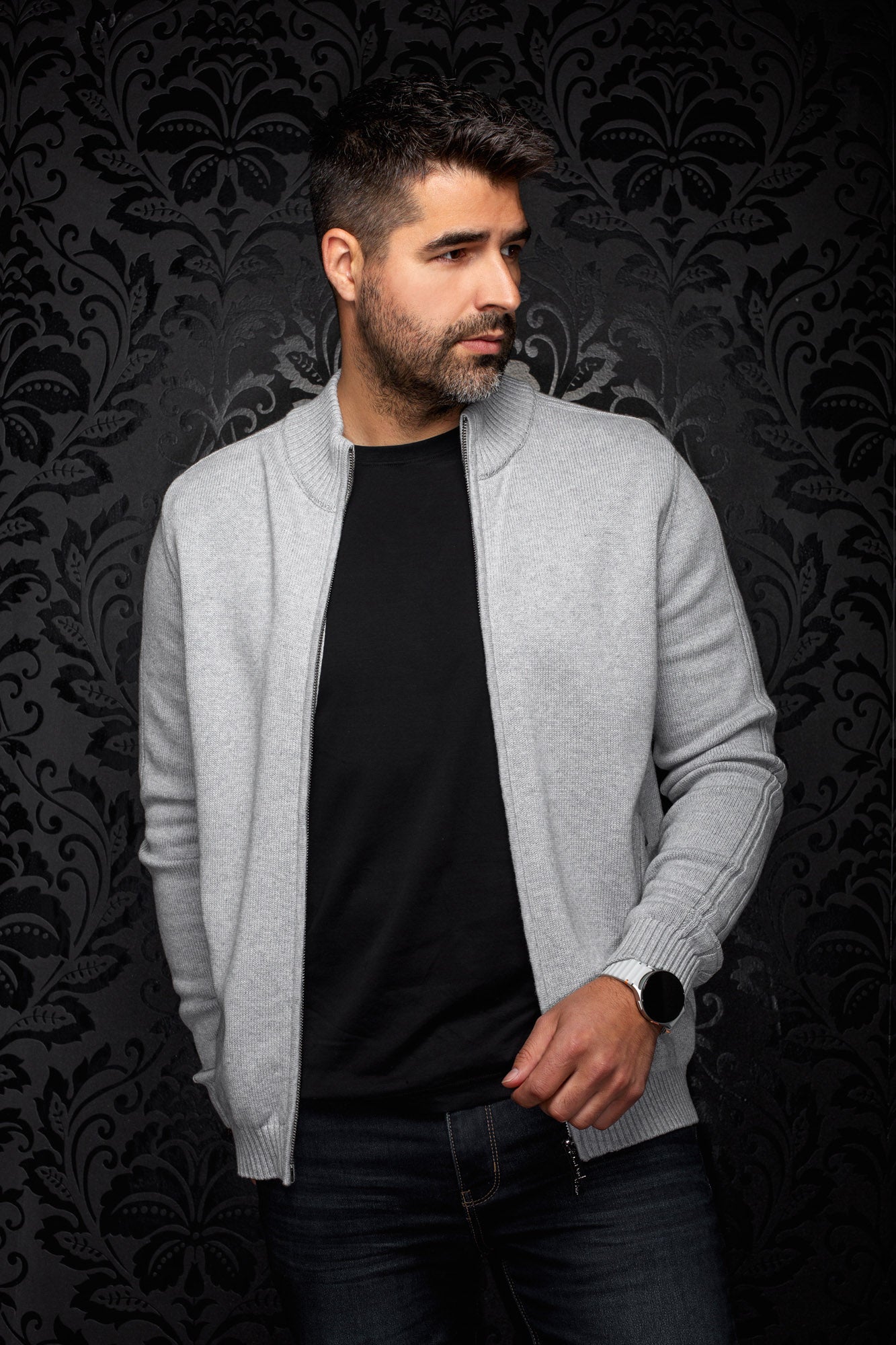 Front model view of men's light gray knit zip cashmere jacket worn open with ribbed collar and cuffs by Au Noir