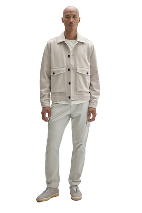 Men's full front view of cream textured button-front jacket with dark buttons and flap pockets by Robert Barakett