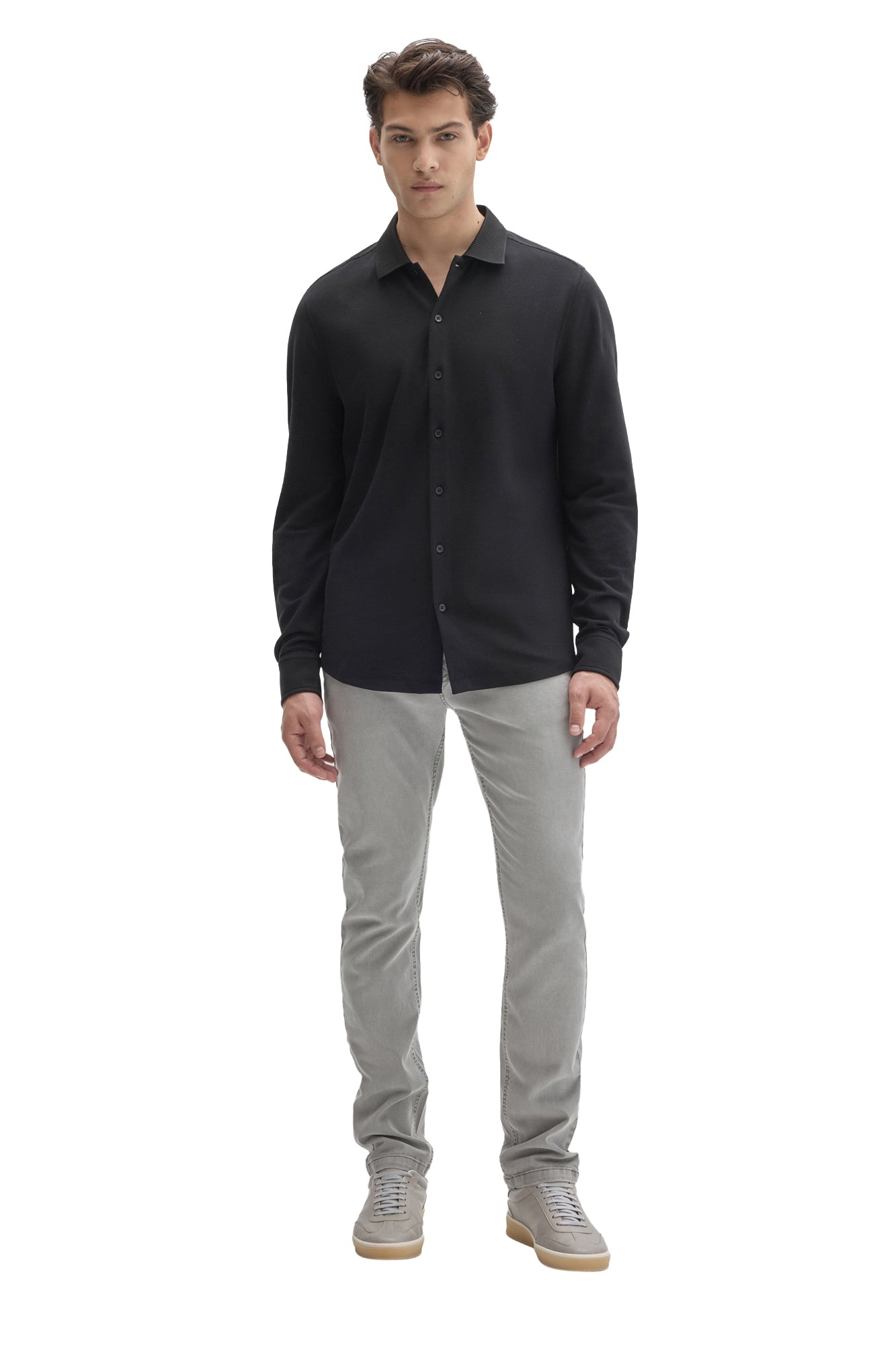 Men's full-body front view of black knit long sleeve shirt with button front and ribbed collar by Robert Barakett