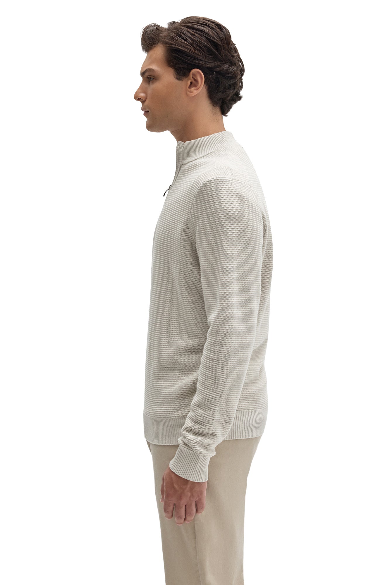 Side view of men's off-white half-zip knit long-sleeve knit sweater showing ribbed hem by Robert Barakett