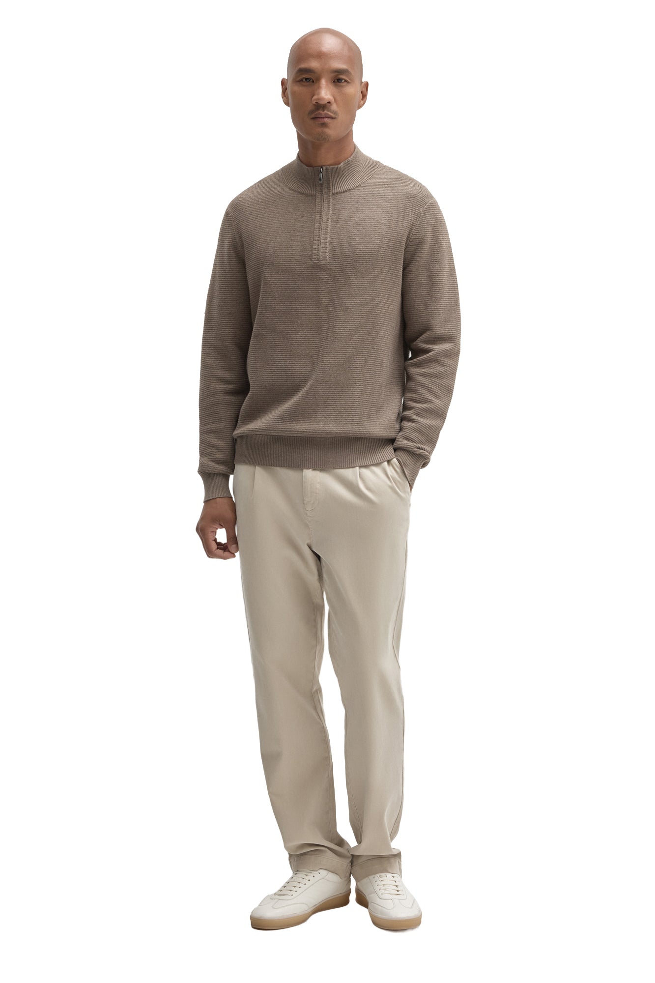 Men's full-length front view of taupe quarter-zip knit long-sleeve knit sweater styled with light pants by Robert Barakett