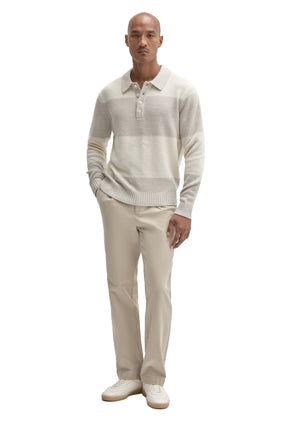 Men's full-body front view of ivory textured long sleeve knit polo with beige pants and ribbed hem by Robert Barakett