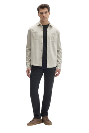 Men's full-body front view of cream tonal plaid overshirt worn open with button cuffs and chest pockets by Robert Barakett