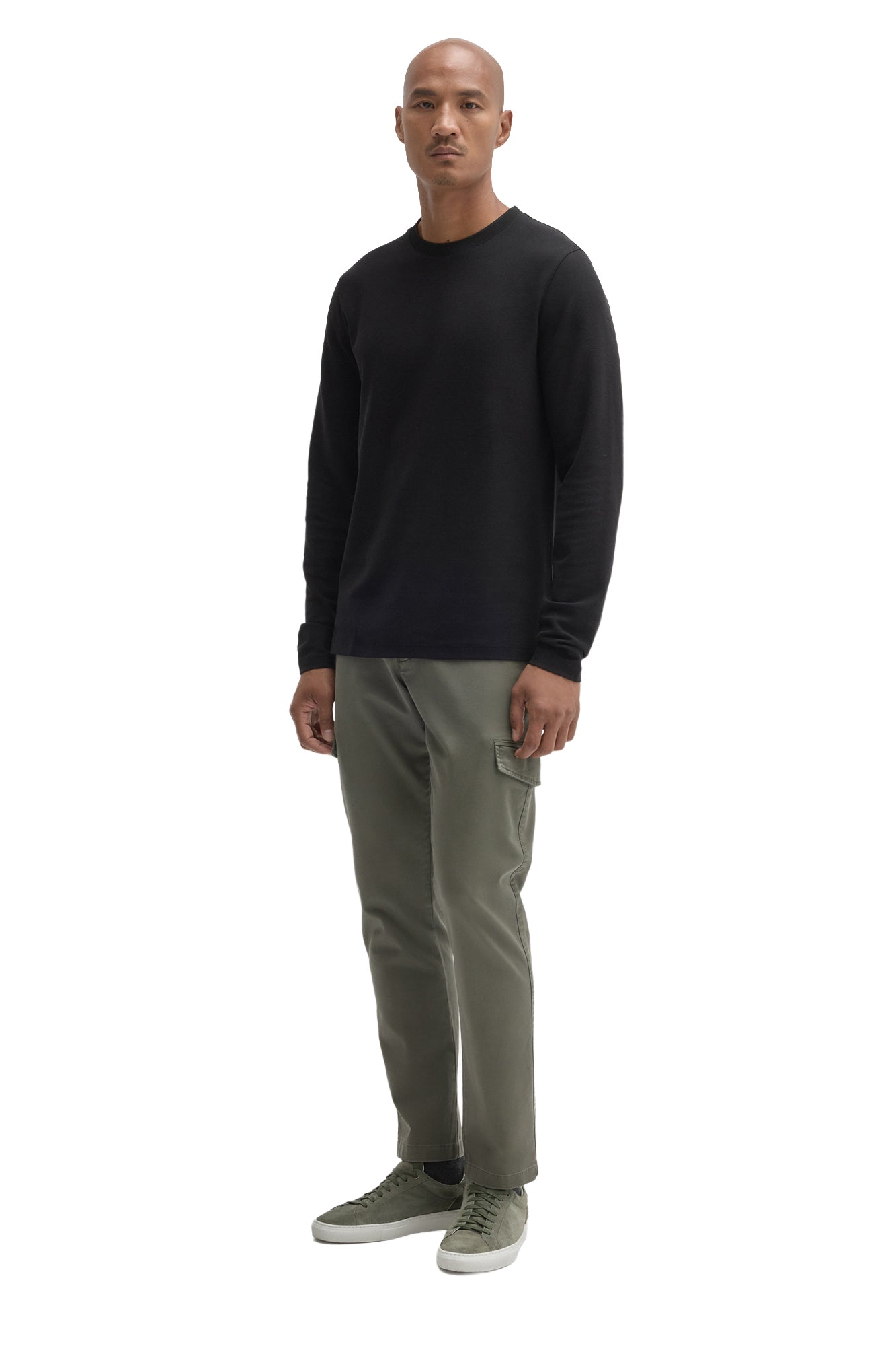 Men's full-body angled view of black long sleeve crew neck T-Shirt styled, front model view by Robert Barakett