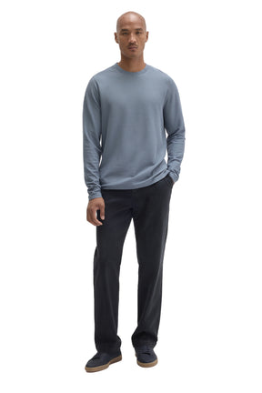 Men's full-length front view of blue-gray long sleeve crewneck T-Shirt styled with dark pants by Robert Barakett