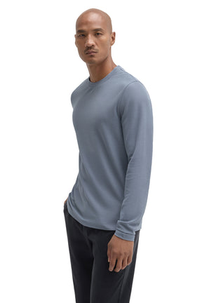 Men's angled front view of blue-gray long sleeve crewneck T-Shirt with fine textured surface by Robert Barakett