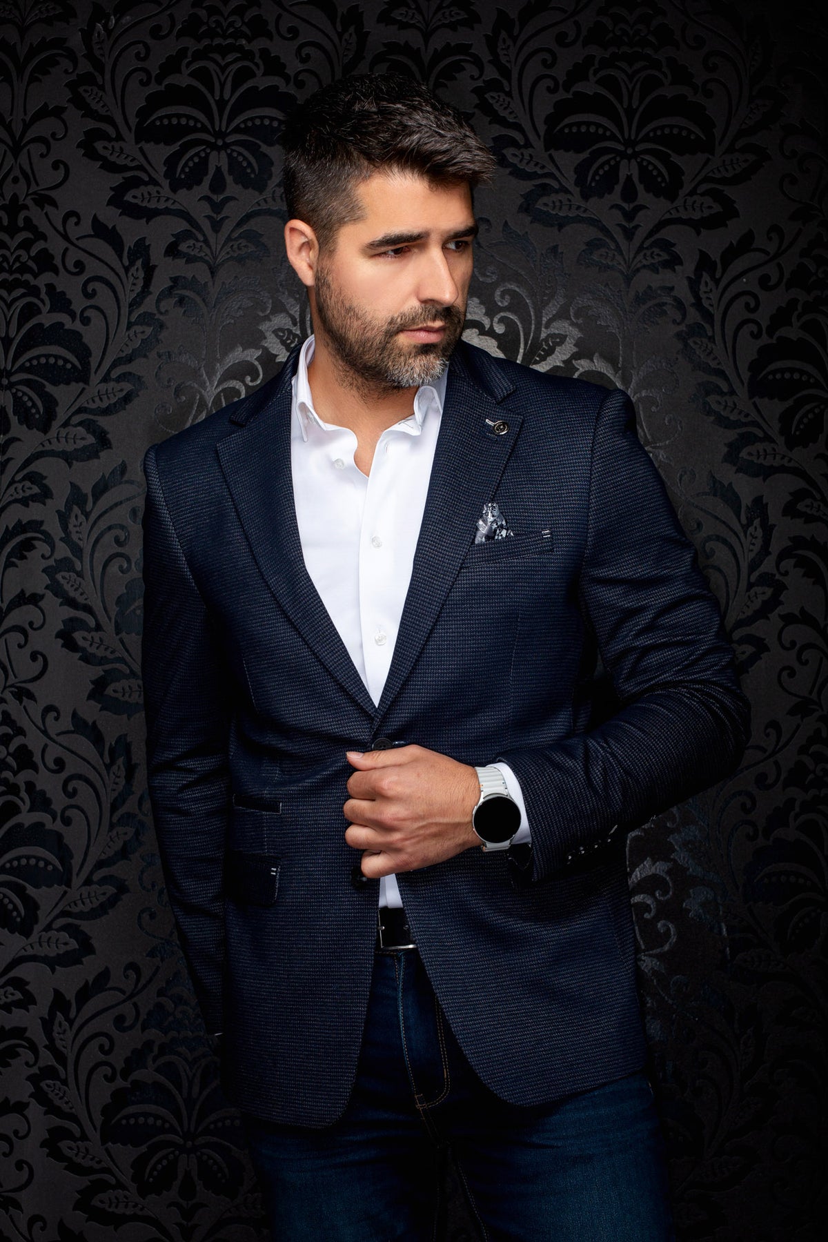 Au Noir men's navy micro-check blazer front view with notched lapels, lapel pin, and flap pockets