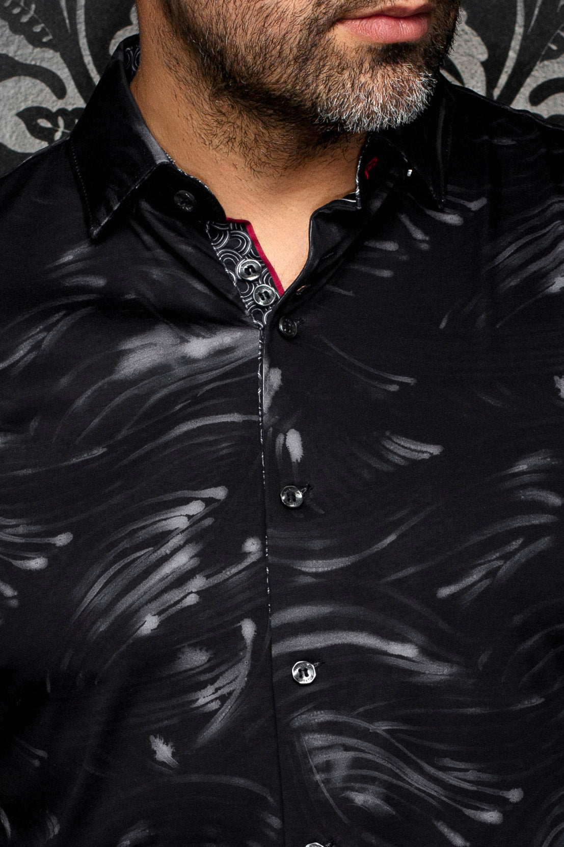 Au Noir men's black button-up shirt collar, gray brushstroke print, patterned placket, and red trim, close-up