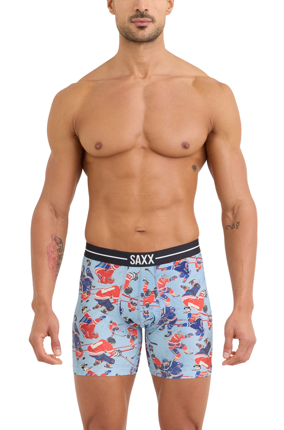 Men's light blue hockey print boxer briefs with pouch seam and black SAXX waistband, front model view