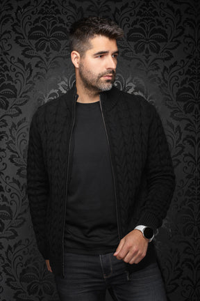 Au Noir men's angled model view of a black cable-knit zip merino jacket worn open, with ribbed collar and cuffs, side view