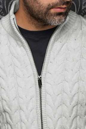 Gros plan de la veste en mérinos gris pâle en tricot torsadé, col montant côtelé et zip foncé pour homme par Au Noir