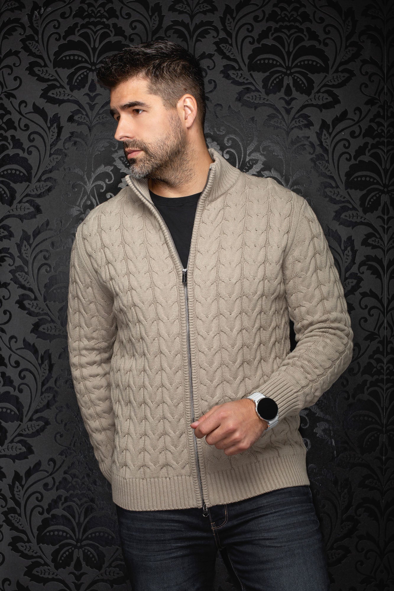 Men's beige cable-knit zip merino sweater shown front on model, with stand collar and ribbed hem by Au Noir