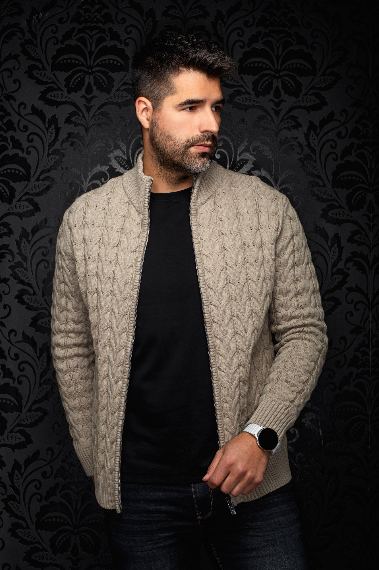 Au Noir men's beige cable-knit zip merino jacket worn open on a model, with ribbed stand collar and cuffs, front view