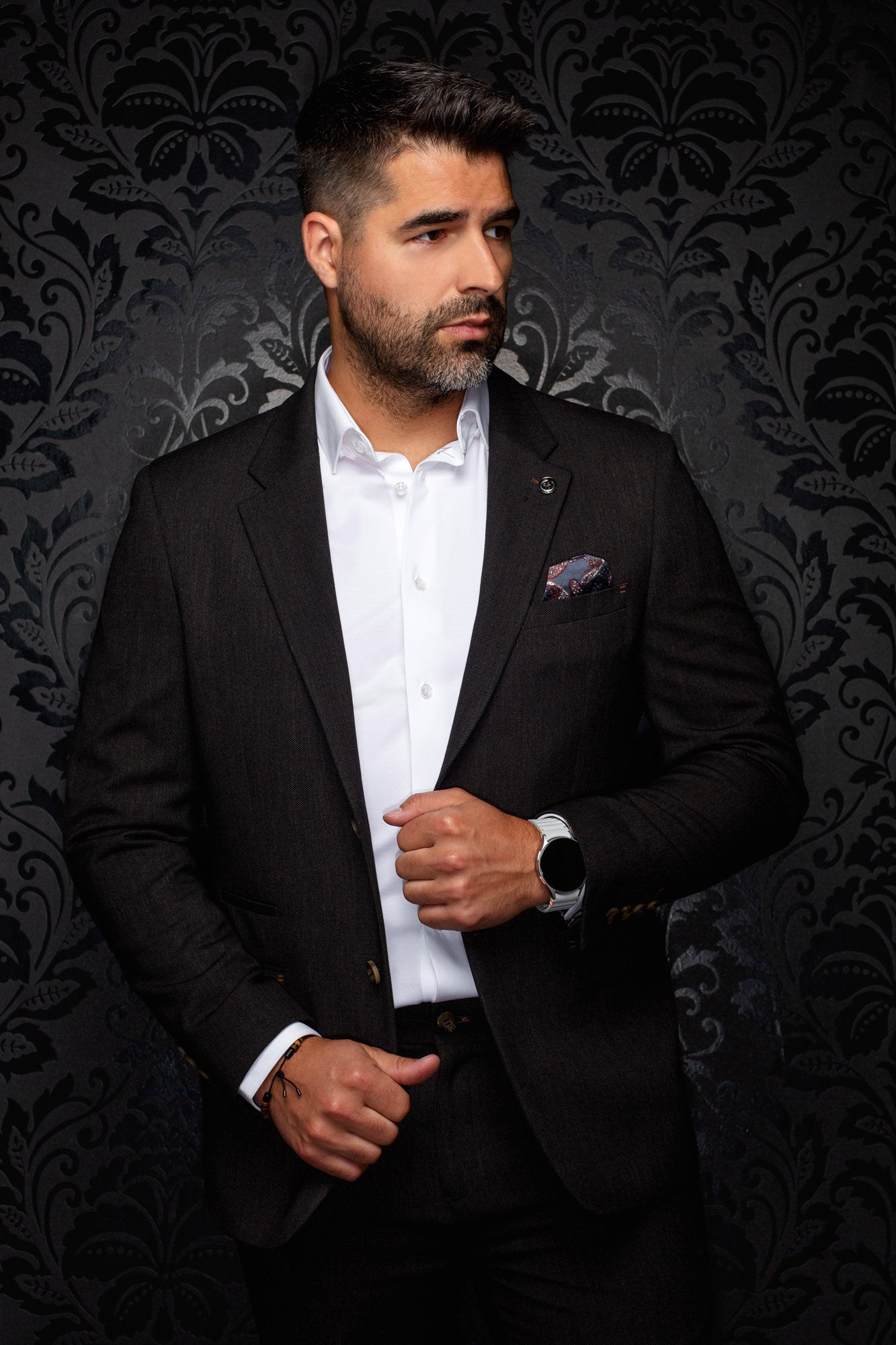 Au Noir men's dark brown blazer with notched lapels, chest pocket, and gold-tone cuff buttons, front view