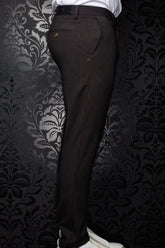 Au Noir men's dark brown pants side view with buttoned back welt pocket and waistband patch